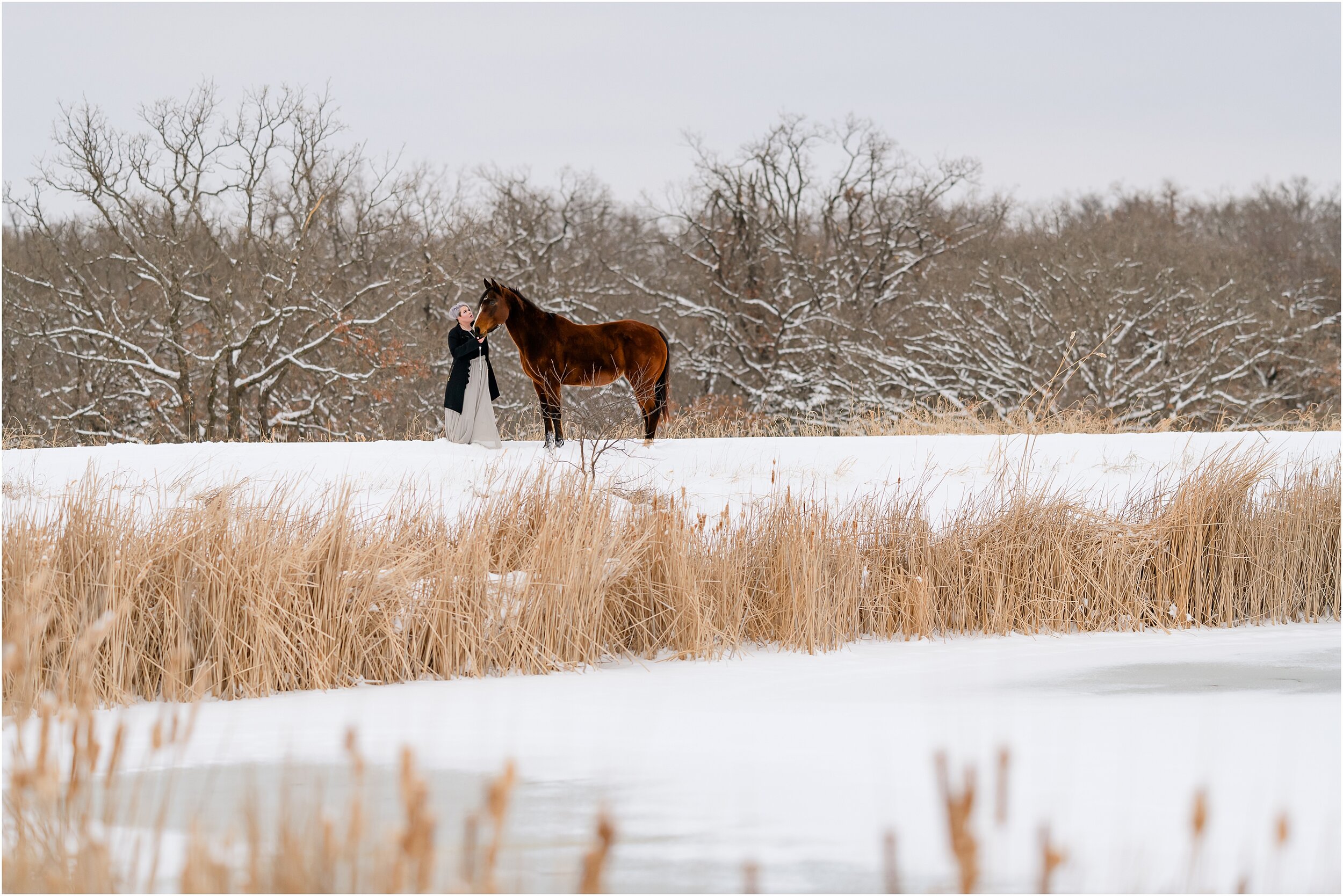 Landscape image of scenic edmond oklahoma in the snow, including a girl with short grey hair in a winter dressy outfit and her bay quarter horse mare. Posing for a girl and her horse in winter.  